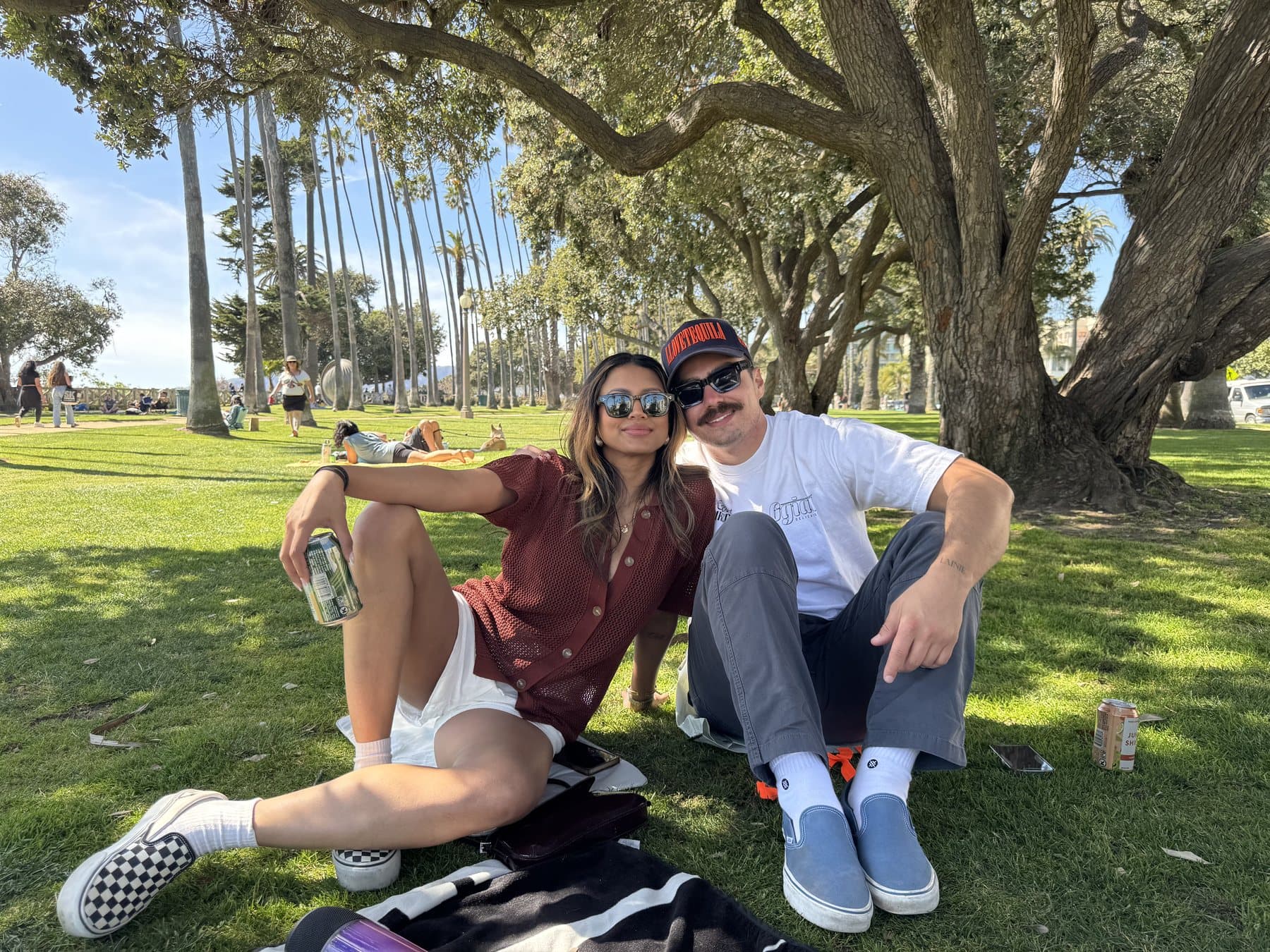 Anishka and Jack sitting together beneath the trees at Palisades Park
